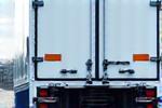 Refrigerated truck with cooling unit visible.